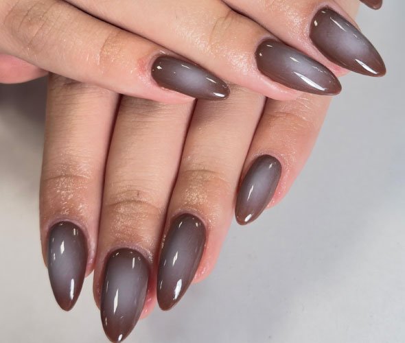 Brown matte acrylic nails on hands